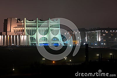 Night panorama of the big city at the foot of the river. Lots of colorful burning lights and street lighting. Top view of houses Stock Photo