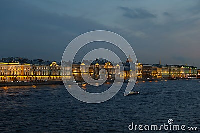 Night Panorama of Brightly Lit Buildings of the Embankment, Reflected in the Waters of the Neva River Stock Photo
