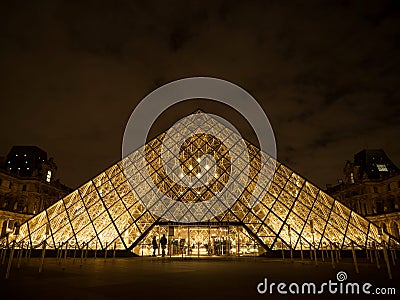 Night panorama of Louvre pyramid glass design architecture museum building construction in Paris France Europe Editorial Stock Photo