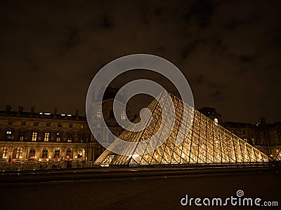 Night panorama of Louvre pyramid glass design architecture museum building construction in Paris France Europe Editorial Stock Photo