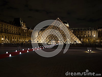 Night panorama of Louvre pyramid glass design architecture museum building construction in Paris France Europe Editorial Stock Photo