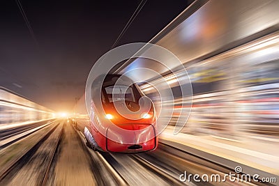 Night passenger high-speed train passing the station in the city Stock Photo