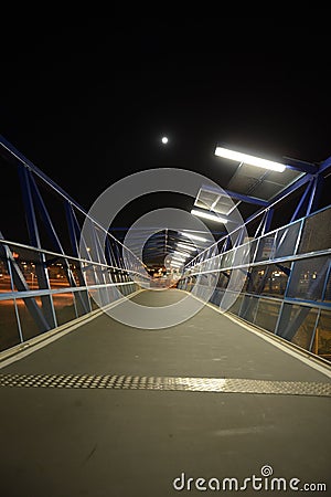 Night pedestrian bridge over the highway in Orihuela Costa. Stock Photo