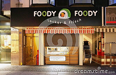 Night photo of a fast food store with the funny name of Foody Foody in Germany. Editorial Stock Photo