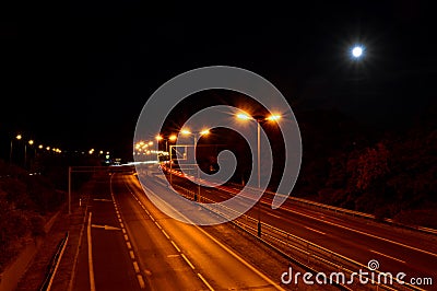 Empty road at night with orange lights Stock Photo