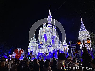 Night photo Magic Kingdom Disney Castle draped with holiday lights Editorial Stock Photo