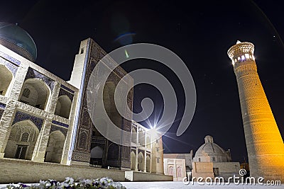 Night photo shoot of ancient buildings in the old town of Bukhara, Central Asia. Kalyan minaret of Poi Kalyan Stock Photo