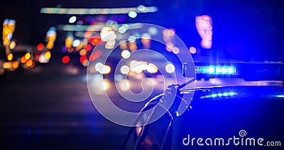 Night police car lights in city - close-up with selective focus and bokeh Stock Photo