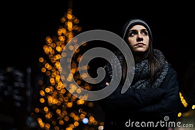 Night portrait of a sad woman feeling alone and depressed in winter.Winter depression and loneliness concept Stock Photo