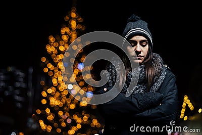 Night portrait of a sad woman feeling alone and depressed in winter.Winter depression and loneliness concept Stock Photo