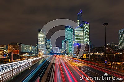 Night road with skyscrapers of La Defense, Paris, France. Stock Photo