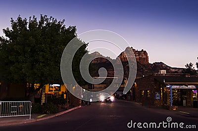 Night scene in the city of Sedona. Cars and shops in the foreground and a view of the mountains in the background Editorial Stock Photo