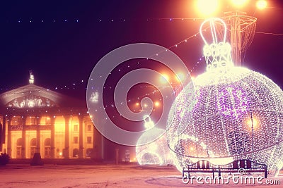 Night scene with illuminated Christmas balls and theater Stock Photo