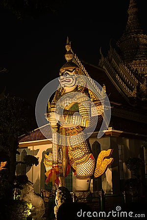 Night scene Thai Giant guardian at front entrance of the `Ordination Hall` in Wat Arun Ratchawararam. Stock Photo