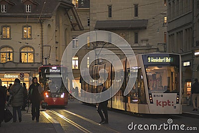 Night scenes from the center of Bern with people on the street, tourist sights and legendary trams or buses. Editorial Stock Photo
