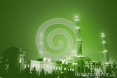 Night sityscape with mosque in the green haze Stock Photo