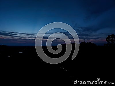 Night sky background, sunset wallpaper, nature photography, dark clouds in blue sky over the city Stock Photo