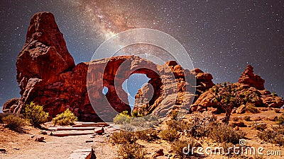 The night sky and milky way over the delicate Sandstone Arch of the Turret Arch in Arches National Park Utah, United States under Stock Photo