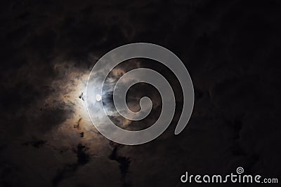 The night sky, moon hiding behind the clouds Stock Photo