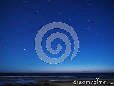 Night sky stars over sea venus auriga constellation Stock Photo