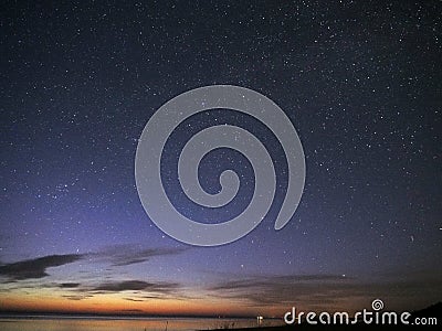 Night sky stars observing Perseus constellation over sea Stock Photo