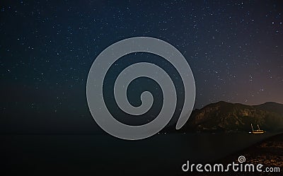 Night starry sky at the sea coast in Cirali, Turkey - landscape exterior. Stock Photo