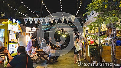 Night street food market in Bangkok, Thailand bustling with shoppers and vendors Editorial Stock Photo