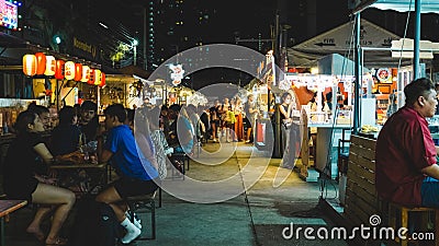 Night street food market in Bangkok, Thailand bustling with shoppers and vendors Editorial Stock Photo