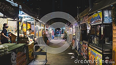 Night street food market in Bangkok, Thailand bustling with shoppers and vendors Editorial Stock Photo