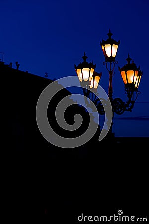 Night street lantern view in urban square with background building black silhouette outline frame shape, vertical photo Stock Photo