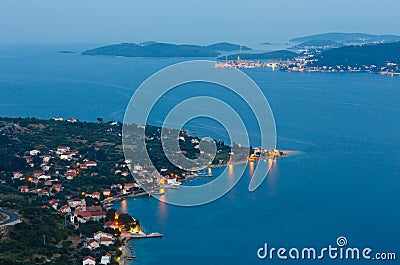 Night summer coastline and village on seashore Stock Photo