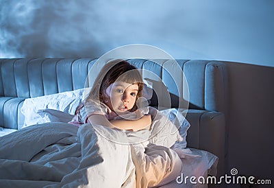 The girl feels the fear while lying in bed Stock Photo