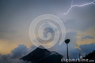 Night thunder storm. Lightning with sunset and clouds over volcano Fuego. Stock Photo