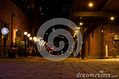 Night time old street with yellow lights. distillery district Toronto downtown Editorial Stock Photo