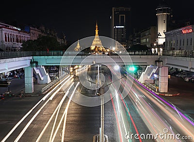 Night time and speed of light of golden octagon of Sule pagoda at Square foot overpass on the crossroad of Anawrahta Rd. and Sule Editorial Stock Photo