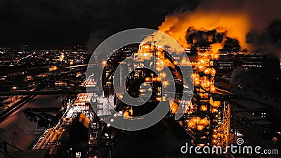 Night top view of blast furnace of a metallurgical plant. Bright lights, smoke and smog of an industrial area Stock Photo