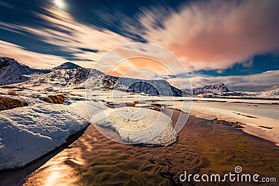 Night on Utakleiv beach, Norway, Europe. Fool moon light illuminatied winter hills on Lofoten Islands Stock Photo