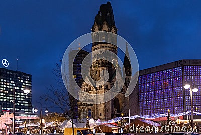 Night view of Breitscheidplatz square with ancient clock tower of Kaiser Wilhelm Memorial Church named `the hollow tooth` Berlin. Editorial Stock Photo