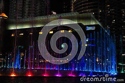Night view of the dancing multi-colored fountains. Show of Singing Fountains Editorial Stock Photo