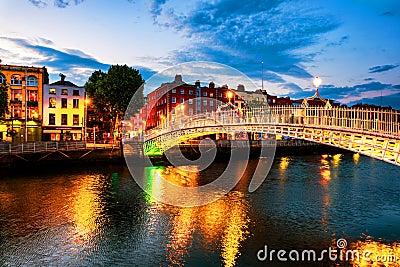 Night view of famous illuminated Ha Penny Bridge in Dublin, Ireland at sunset Stock Photo