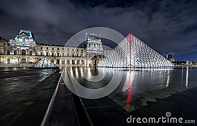 Night view of The Louvre museum with crystal pyramid Editorial Stock Photo