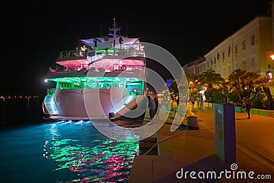 Night view of Mali LoÅ¡inj harbor and marina in medieval old town Mali LoÅ¡inj. Mooring luxury yachts, boats and other vessels on Editorial Stock Photo