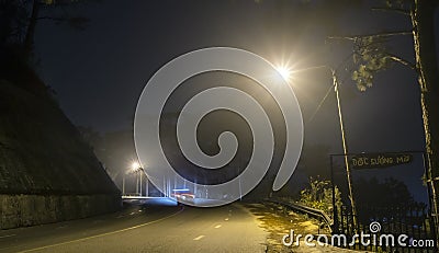 The night view of the pass road is full of fog with magical street lights Stock Photo