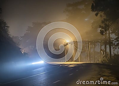 The night view of the pass road is full of fog with magical street lights Stock Photo