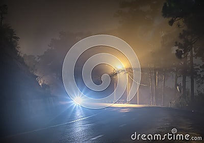 The night view of the pass road is full of fog with magical street lights Stock Photo