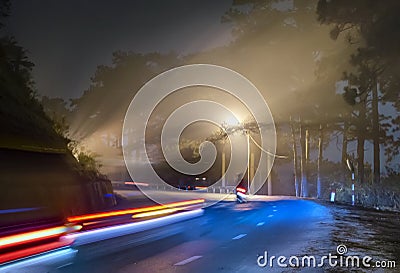 The night view of the pass road is full of fog with magical street lights Stock Photo