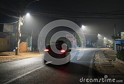 The night view of the pass road is full of fog with magical street lights Stock Photo