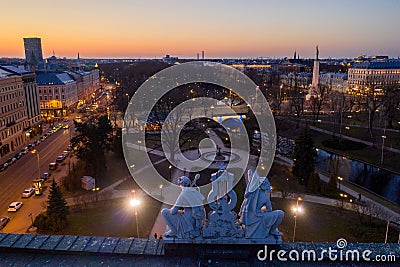 Night view of Riga seen through Latvian National Opera statue Stock Photo