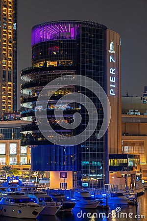 Night view to Dubai Marina panorama, reveals Pier 7 and boats. Luxury destination for tourists and residents. Editorial Stock Photo