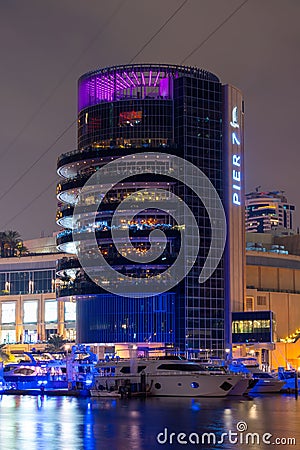 Night view to Dubai Marina panorama, reveals Pier 7 and boats. Luxury destination for tourists and residents. Editorial Stock Photo